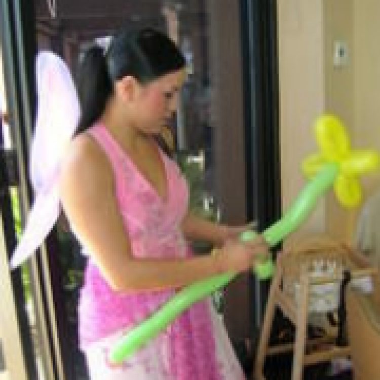 Fairy entertainer twisting a balloon flower