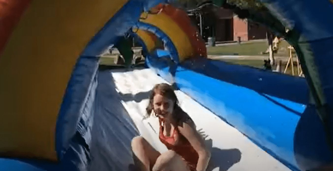 Girl sliding down a water slide